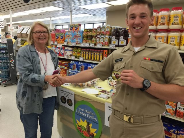A sailor wins a Commissary Gift Card during a giveaway at the Naval Air Station Whiting Field, Florida, Commissary. Whiting Field won the 2015 Defense Commissary Agency's Richard M. Pagent Award for the Best Small Commissary in the United States. DeCA photo