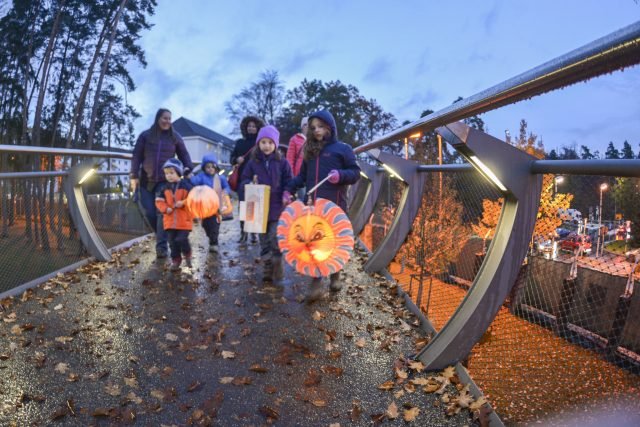 Families walk with lanterns across the pedestrian bridge on Panzer Kaserne to celebrate the German holiday, St. Martin's Day, Nov. 10, 2016. Photo by Kevin S. Abel.
