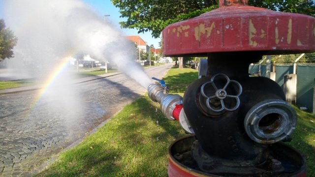 A fire Hydrant sprays water