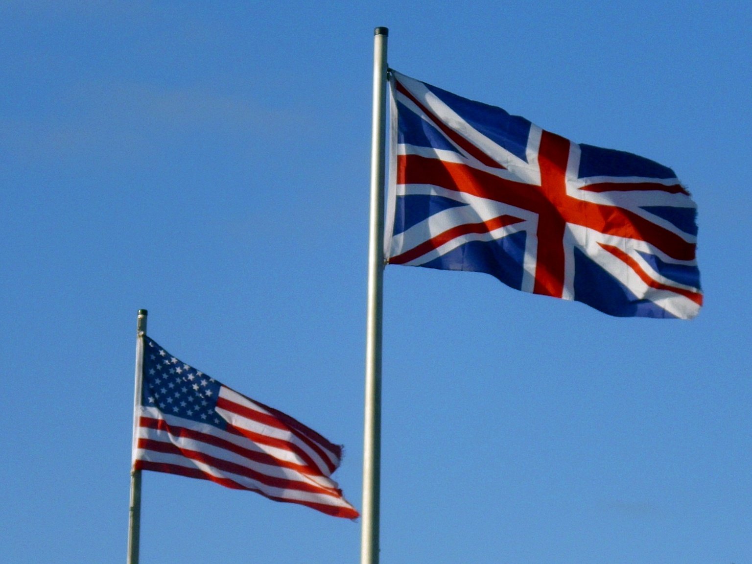 The flags of the UK and the US fly in the wind
