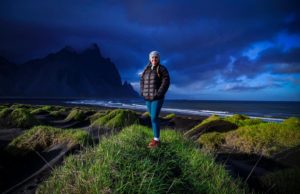 A girl stands in front of a beautiful icelandic scene